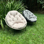 Load image into Gallery viewer, Two cushioned chairs on a grassy area with greenery in the background
